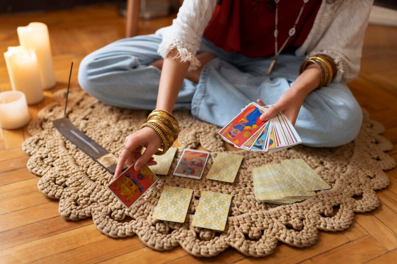 high-angle-woman-reading-tarot-home