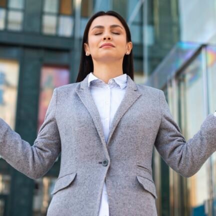 low-angle-businesswoman-zen-pose